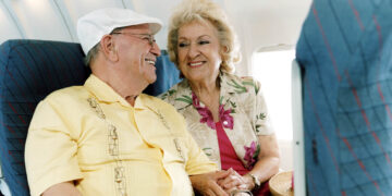 Senior Couple Smiling at Each Other on a Plane
